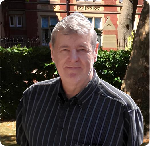 Dr Stephen B Fauguel, Ph.D. smiling outside in a university